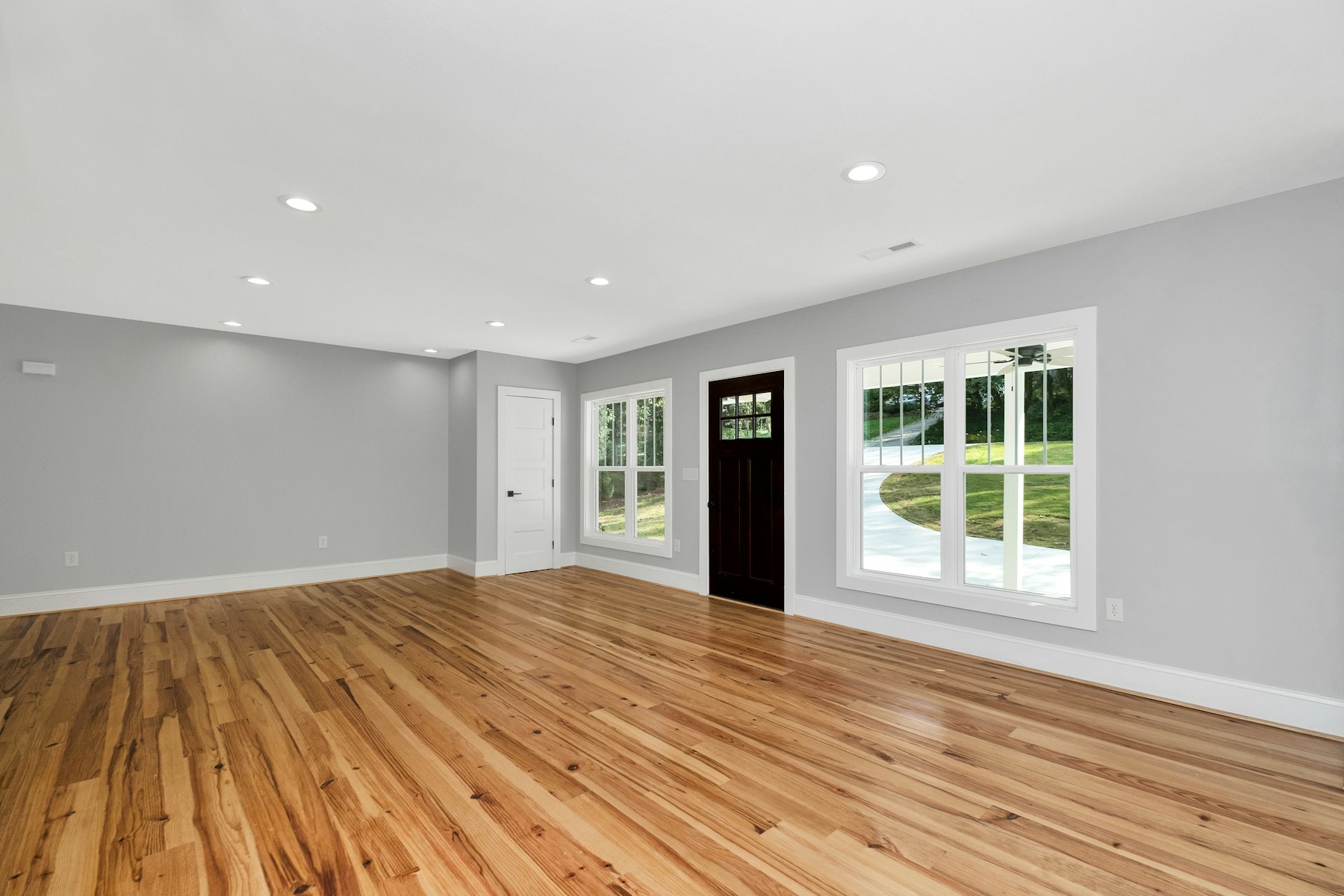 Sitting room with heart pine floors and white plaster walls